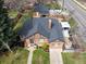 An aerial perspective presents the home's brick facade, meticulously landscaped yard, and a charming gazebo at 795 N Jersey St, Denver, CO 80220