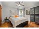 Cozy bedroom with hardwood floors, ceiling fan, a large bed, and ample natural light at 795 N Jersey St, Denver, CO 80220