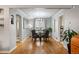 Bright dining room with hardwood floors, modern chandelier, and large window for ample natural light at 795 N Jersey St, Denver, CO 80220