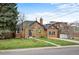 Beautiful brick home featuring a lush green lawn, mature trees, and a welcoming entrance at 795 N Jersey St, Denver, CO 80220