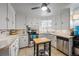 Bright kitchen with white cabinets, stainless steel appliances, and tile countertops at 795 N Jersey St, Denver, CO 80220
