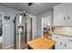 Modern kitchen with stainless steel refrigerator and a glimpse of the living area at 795 N Jersey St, Denver, CO 80220