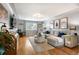 Bright and spacious living room featuring hardwood floors, a sectional sofa, and large window at 795 N Jersey St, Denver, CO 80220