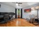 Well-lit living room with hardwood floors, ceiling fan, comfortable seating, and stylish decor at 795 N Jersey St, Denver, CO 80220