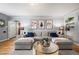 Comfortable living room with stylish decor, a plush sectional sofa, and hardwood floors at 795 N Jersey St, Denver, CO 80220