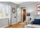 Inviting living room with hardwood floors, a sunburst mirror, and a cozy seating arrangement at 795 N Jersey St, Denver, CO 80220