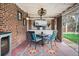 Charming covered outdoor patio with a brick wall, comfortable seating, and a cozy ambiance for relaxing at 795 N Jersey St, Denver, CO 80220