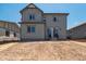 Backyard view of the two-story gray house showcasing a sliding glass door and neutral surroundings at 8339 Snake River St, Littleton, CO 80125
