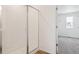 Bathroom featuring a tiled shower with glass doors, bright lighting, and vinyl flooring at 8339 Snake River St, Littleton, CO 80125
