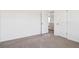 Bedroom featuring neutral carpet, white walls, and an open doorway at 8339 Snake River St, Littleton, CO 80125