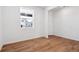 Inviting room with hardwood floors, white walls, and a window offering natural light at 8339 Snake River St, Littleton, CO 80125