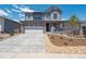 Charming two-story home with stone accents, landscaped yard, and two car garage at 8339 Snake River St, Littleton, CO 80125