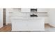 Modern kitchen featuring stainless steel appliances and a large kitchen island at 8339 Snake River St, Littleton, CO 80125
