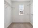 Walk-in closet features carpet, window, and metal shelving at 8339 Snake River St, Littleton, CO 80125