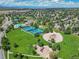 An aerial view shows tennis courts, playground, pool and green spaces nestled within the residential neighborhood at 5416 S Hannibal Ct, Centennial, CO 80015