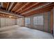 Spacious unfinished basement with concrete floors and walls, exposed beam ceiling, and natural light from windows at 5416 S Hannibal Ct, Centennial, CO 80015