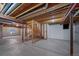 Unfinished basement with exposed ceiling, cement floor, and framed stairway at 5416 S Hannibal Ct, Centennial, CO 80015