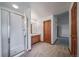 Bathroom featuring a white shower and a wood vanity with light wood cabinets at 5416 S Hannibal Ct, Centennial, CO 80015