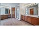 Spacious bathroom featuring a double vanity with wood cabinets and a glass enclosed shower at 5416 S Hannibal Ct, Centennial, CO 80015