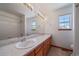 Well-lit bathroom features a double vanity with wood cabinets and a shower with tub at 5416 S Hannibal Ct, Centennial, CO 80015