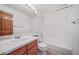 Well-lit bathroom featuring a vanity with a wood cabinet and white shower and tub at 5416 S Hannibal Ct, Centennial, CO 80015