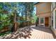 A pleasant outdoor wood deck offering views of the lush greenery, nearby house siding, and sliding glass door access at 5416 S Hannibal Ct, Centennial, CO 80015