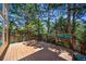 Outdoor deck surrounded by lush greenery and mature trees, offering a private and serene outdoor living space at 5416 S Hannibal Ct, Centennial, CO 80015