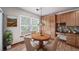 Cozy dining area adjacent to the kitchen, featuring a window with natural light and comfortable seating at 5416 S Hannibal Ct, Centennial, CO 80015