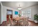 Cozy dining room features natural wood floors, a charming rug, and ample natural light from the window at 5416 S Hannibal Ct, Centennial, CO 80015