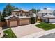 Beautiful two-story home featuring a three-car garage, brick accents, and a well-manicured front yard and brick paver driveway at 5416 S Hannibal Ct, Centennial, CO 80015