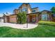 Attractive two-story home with brick accents, lush landscaping, and a manicured front lawn; a welcoming and well-maintained exterior at 5416 S Hannibal Ct, Centennial, CO 80015