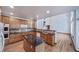 Well-lit kitchen with a large island, granite countertops, stainless steel appliances, and ample storage at 5416 S Hannibal Ct, Centennial, CO 80015