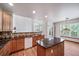 Open-concept kitchen with granite countertops, a center island, and views of the living area at 5416 S Hannibal Ct, Centennial, CO 80015