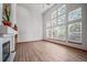 Open living room with fireplace and hardwood floors, bathed in natural light from tall windows, perfect for entertaining at 5416 S Hannibal Ct, Centennial, CO 80015