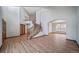 Bright, open-concept living room features hardwood floors, staircase, and archway with natural light, creating a welcoming space at 5416 S Hannibal Ct, Centennial, CO 80015