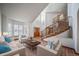 Inviting living room features a staircase, large windows, hardwood floors, and comfortable seating, perfect for relaxation at 5416 S Hannibal Ct, Centennial, CO 80015