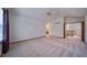 Large carpeted bedroom with high ceilings, a ceiling fan and adjacent bathroom and staircase at 5416 S Hannibal Ct, Centennial, CO 80015