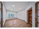 Bright office featuring hardwood floors, built-in bookshelves, and a window with shutters for a professional ambiance at 5416 S Hannibal Ct, Centennial, CO 80015