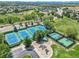 A high aerial shot of tennis courts, playground, and parking, all surrounded by lush, mature trees at 5416 S Hannibal Ct, Centennial, CO 80015