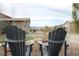 Scenic backyard view with Adirondack chairs, professionally landscaped yard, and mountain views at 10526 Fairhurst Way, Highlands Ranch, CO 80126