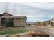 Well-maintained backyard with manicured lawn, mature trees, and split-rail fencing at 10526 Fairhurst Way, Highlands Ranch, CO 80126