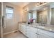 Bright bathroom with double vanity, sleek countertops and a glass-enclosed shower at 10526 Fairhurst Way, Highlands Ranch, CO 80126