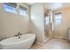 Elegant bathroom with a soaking tub and glass enclosed shower, complemented by stylish hexagon tile flooring at 10526 Fairhurst Way, Highlands Ranch, CO 80126