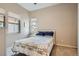 Bright bedroom with a quilt bedspread, cozy carpeting and two windows that bring in lots of natural light at 10526 Fairhurst Way, Highlands Ranch, CO 80126