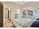 Cozy bedroom with a patchwork quilt, white dresser and ample natural light through the windows at 10526 Fairhurst Way, Highlands Ranch, CO 80126