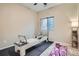 At home exercise space with pilates machine, purple yoga mat and shelving for workout accessories at 10526 Fairhurst Way, Highlands Ranch, CO 80126