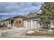 Charming home featuring a two-car garage, brick accents, and professionally landscaped grounds at 10526 Fairhurst Way, Highlands Ranch, CO 80126