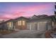 Charming home exterior with brick accents and a spacious two-car garage, perfect for suburban living at 10526 Fairhurst Way, Highlands Ranch, CO 80126