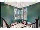 Green landing with decorative art pieces, decorative lights and large bright windows at 10526 Fairhurst Way, Highlands Ranch, CO 80126