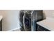 A laundry room with modern washer and dryer units, countertop, and sleek design at 10526 Fairhurst Way, Highlands Ranch, CO 80126